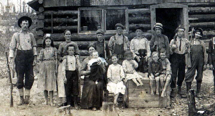 Possibly a Griffith family in front of their log cabin