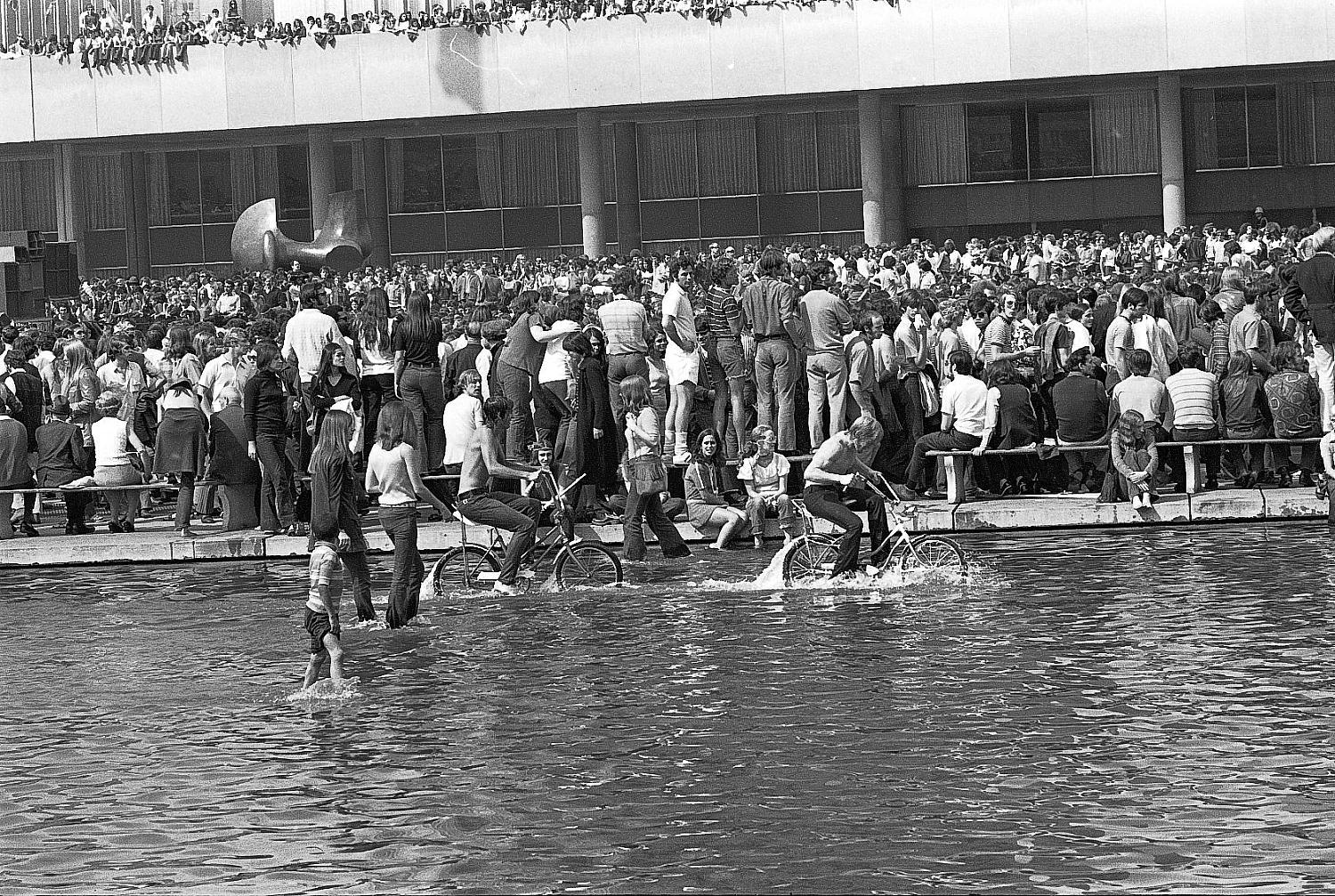 Crowd at Lighthouse Concert at City Hall, Toronto, 1970: crowd scene with people wading in City Hall reflecting pool.