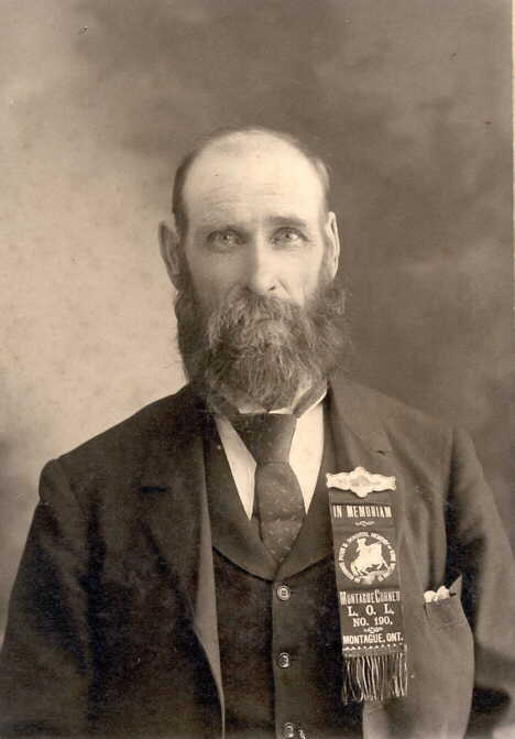Photograph of man wearing Orange Lodge badge